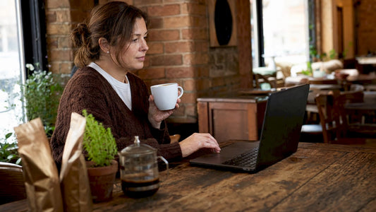 Woman researching coffee and tea alternatives at home