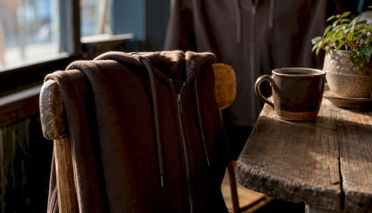 Zip-up hoodie hanging on chair in coffee shop