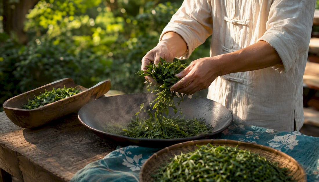 Hands pan-firing fresh green tea leaves