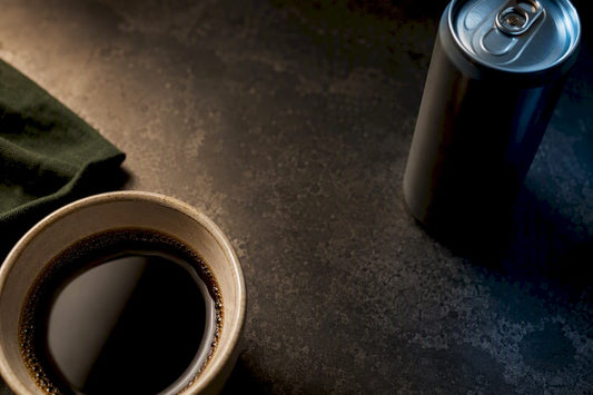 Partial coffee cup and energy drink can